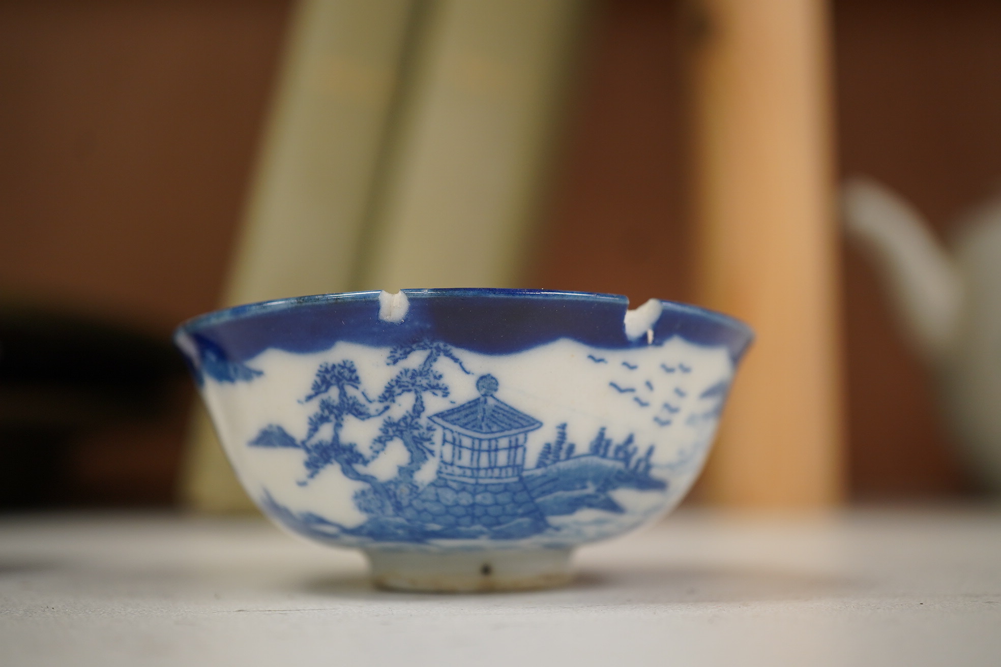 A group of Chinese blue and white porcelain, including a mid 19th century Canton enamel teabowl and a Japanese small dish, tallest 22cm. Condition - fair